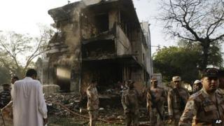 Troops of Pakistan's para-military force stand near the site of an explosion in Karachi, Pakistan on Thursday, Nov. 8, 2012.