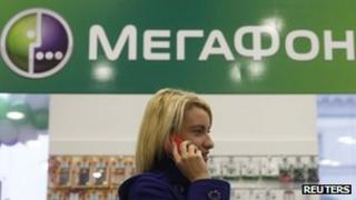 A customer speaks on her phone inside a Megafon shop in St Petersburg