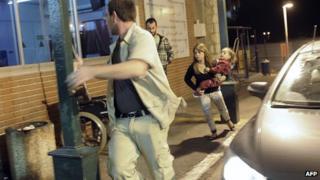 Israelis run for cover as a siren wails across the southern city of Ashkelon