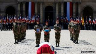 French soldiers honour the coffin of General Bigeard at a ceremony at Les Invalides in Paris
