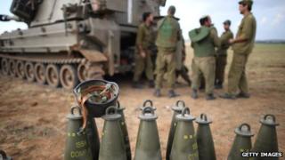 Israeli soldiers prepare an artillery emplacement overlooking Gaza on Israel's border with the Gaza Strip