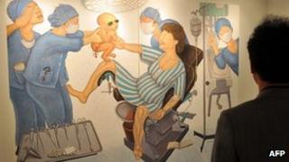 A painting portraying Park Geun-Hye of South Korea's New Frontier Party giving birth to her own father and late strongman, Park Chung-Hee, at a Seoul gallery, 20 November 2012