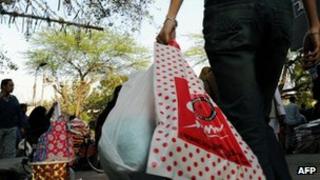 A shopper in Delhi carrying plastic bags