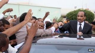 President Abdelaziz waves to crowds