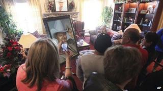 A large portrait of Larry Hagman greets fans as they take a tour of Southfork Ranch, setting for the TV show Dallas, in Parker, Texas