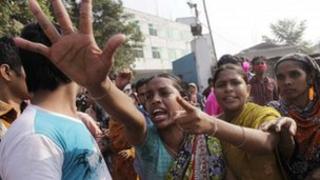 Workers shout slogans as they protest against the death of their colleagues after a devastating fire in a garment factory which killed more than 100 people, in Savar November 26, 2012.