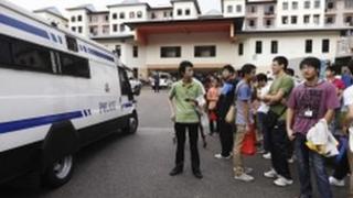 A police van outside the bus drivers' dormitory in Singapore