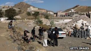 Yemeni men gather at the site of the attack