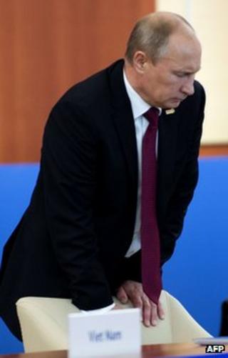 Russian President Vladimir Putin braces himself against a chair at a summit in Vladivostok, 9 September
