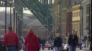People walking along the riverfront in Newcastle