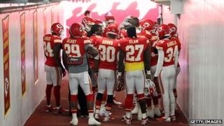 Kansas City Chiefs players huddle in prayer in the tunnel to the field before their game against the Carolina Panthers at Arrowhead Stadium in Kansas City, Missouri, 2 December 2012