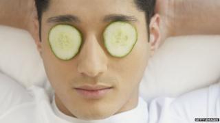 Man using cucumbers on eyes