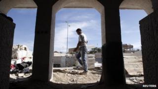 A Palestinian labourer works at a construction site in the West Bank Jewish settlement of Maale Adumim