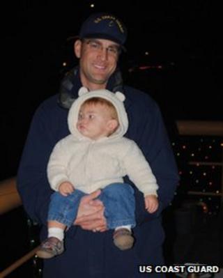 Chief Petty Officer Terrell Horne and child in undated photo provided by US Coast Guard