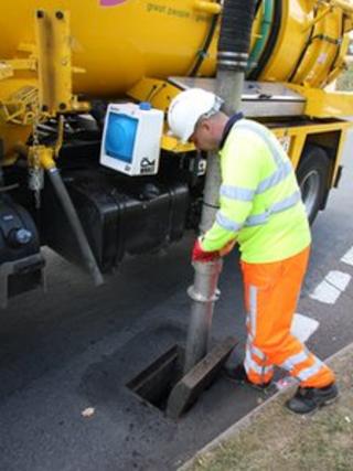 A man cleaning a drain in Northamptonshire