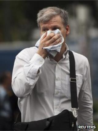 Man in Buenos Aires covers his face