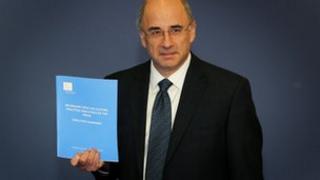 Lord Leveson with his report