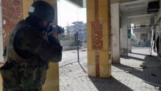 State news agency handout showing Syrian soldier in Damascus suburb of Darayya (2 December 2012)