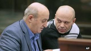 Murder suspect Dmitry Pavlyuchenkov (right) speaks to his lawyer in court, 12 December