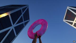 A protester holds a life saver in front of a bank in Madrid. Photo: June 2012
