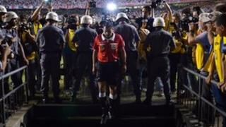 Referee goes to speak with Tigre players during the half time of Copa Sudamericana football final match at Morumbi stadium in Sao Paulo, Brazil, on 12 December 2012