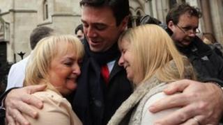 Andy Burnham embraces Jenni Hicks, who lost her two teenage daughters Sarah and Victoria, and Margaret Aspinall, who lost her son James in the Hillsbrough disaster