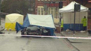 Scene of crime officers work on the car in Streatham High Road