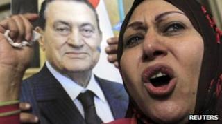 A protester holds a picture of Hosni Mubarak outside the Egyptian High Court in Cairo earlier this week