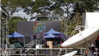 Workers resting as they prepare to set up a stage for the country's first-ever public New Year's countdown at Myoma grounds in Rangoon, 31 December 2012.