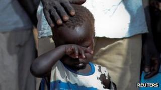 A boy who fled the conflict in Sudan's Blue Nile waits outside a clinic in Doro refugee camp, South Sudan. Photo: March 2012