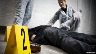 Crime scene technicians investigate a body