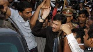 Muslim lawmaker and the leader of Majlis-e-Ittehadul Muslimeen, or the Council of the Union of Muslims, Akbaruddin Owaisi, center in black, makes his way through the crowd as he leaves the Government Gandhi Hospital after medical tests in Hyderabad, India, Tuesday, Jan. 8, 2013