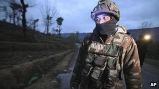 An Indian army soldier patrols near the line of control, the line that divides Kashmir between India and Pakistan, after reported ceasefire violation, in Mendhar, Poonch district, about 210 kilometers (131 miles) from Jammu, India, Wednesday, Jan. 9, 2013.