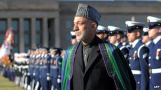 Afghan President Hamid Karzai reviews an honour guard at the Pentagon before his meeting with US Secretary of Defense Leon Panetta 10 January 2013