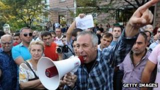A man shouts during a protest rally against torture in prisons as demonstrators block one of the capital's main streets in Tbilisi on September 19, 2012.