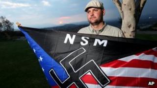Jeff Hall, who was killed by his son, holds a Neo Nazi flag while standing at Sycamore Highlands Park near his home in Riverside, California October 2010