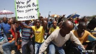 Striking platinum miners march near the Anglo-American Platinum mine near Rustenburg, South Africa, 5 October 2012