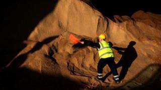 A man shovelling rock salt