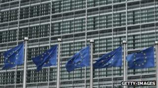 EU flags flying outside the European Commission headquarters in Brussels