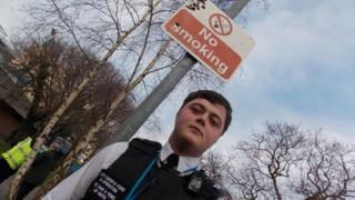 Civil enforcement officer and no smoking sign