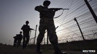 Indian Border Security Force (BSF) soldiers patrol the fenced border with Pakistan in Suchetgarh, southwest of Jammu January 16, 2013.