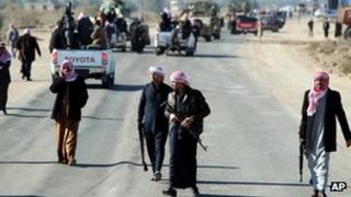 Bodyguards protect the funeral cortege of Sunni MP Eifan Saadoun al-Issawi in Fallujah on Wednesday
