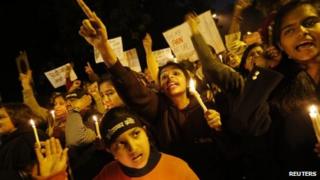 Demonstrators shout slogans and raise their hands during a candlelight march for a gang rape victim, who was assaulted in New Delhi January 16, 2013