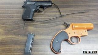 A handgun, ammunition clip and flare gun found in the bag of a sevem-year-old boy, police handout 18 January 2013