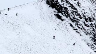 Climbers make their way down the mountains near Glencoe