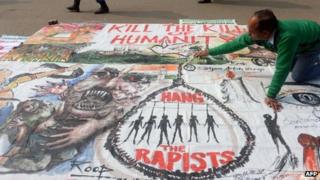 An artists works on a banner calling for the death sentence for rapists in Delhi, 16 January 2012