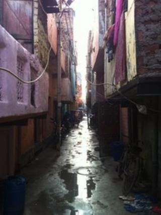 The narrow wet and muddy lane where the victims' family live in Delhi
