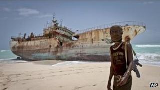A Somali pirate poses in front of a Taiwanese fishing vessel - photo 23 September