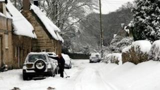 Woman tries to get her vehicle ready for the snow in Rutland