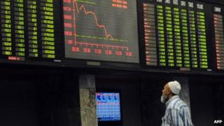 A Pakistani stockbroker watches share prices at the Karachi Stock Exchange (January 2013)